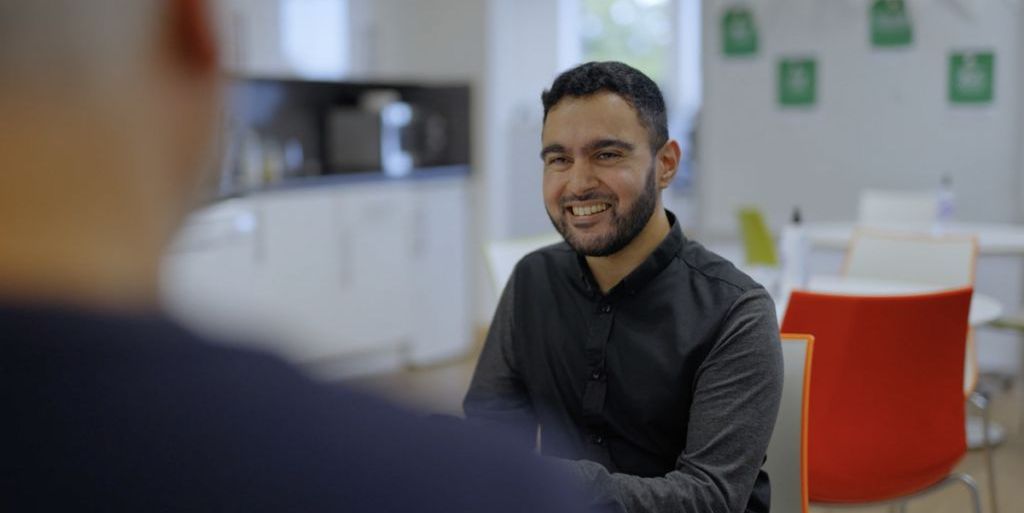 Awais looking at a laptop