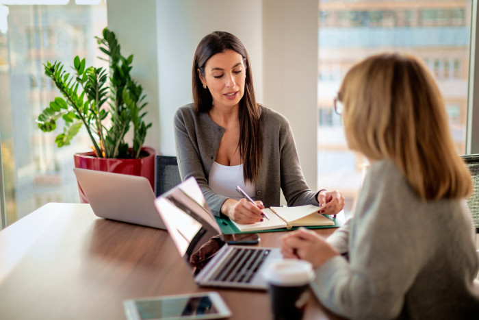 Female_colleagues_working_over_documents.jpg