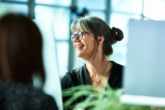 Colleague at computer smiling