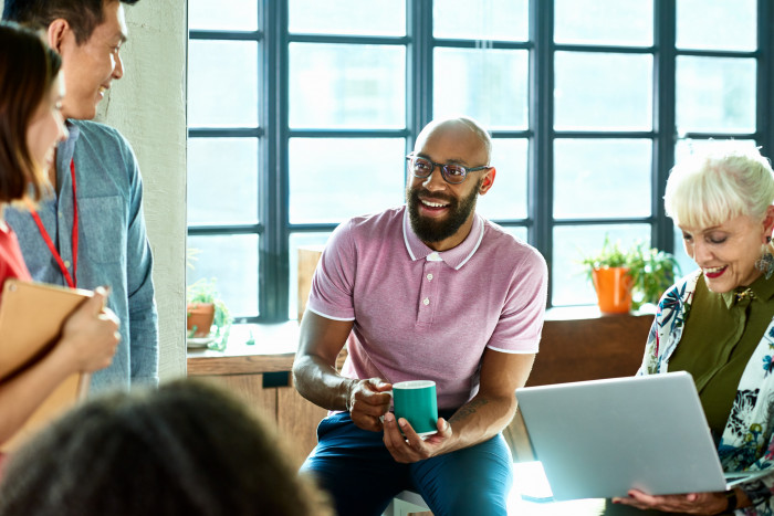 Colleagues laughing in a meeting