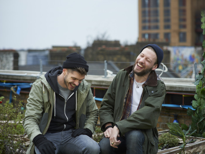 Two men laughing outdoors