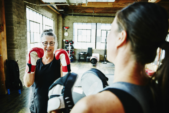 Two women boxing and laughing