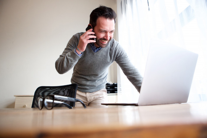 Man working from home on phone and laptop