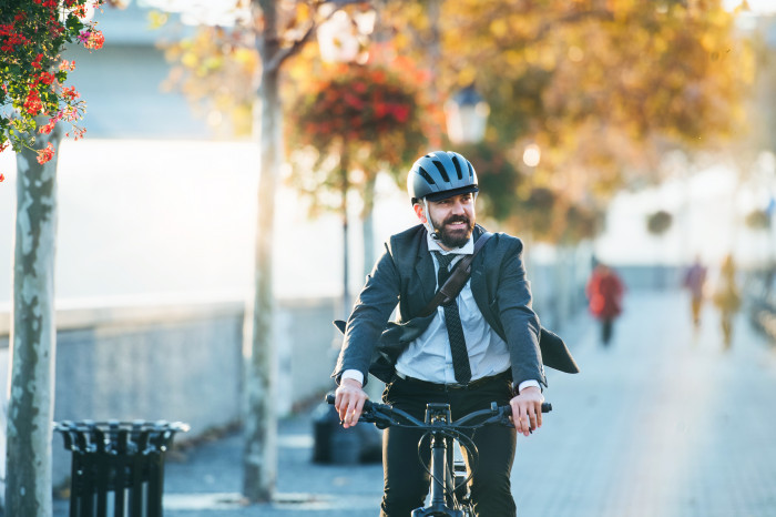 Man riding a bike along the riverside