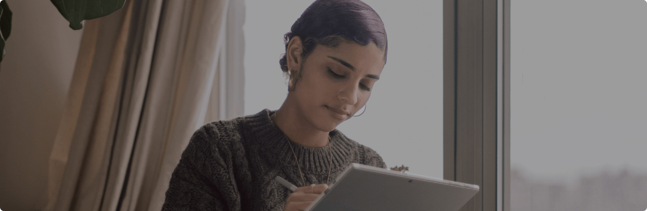 Woman working on tablet at home