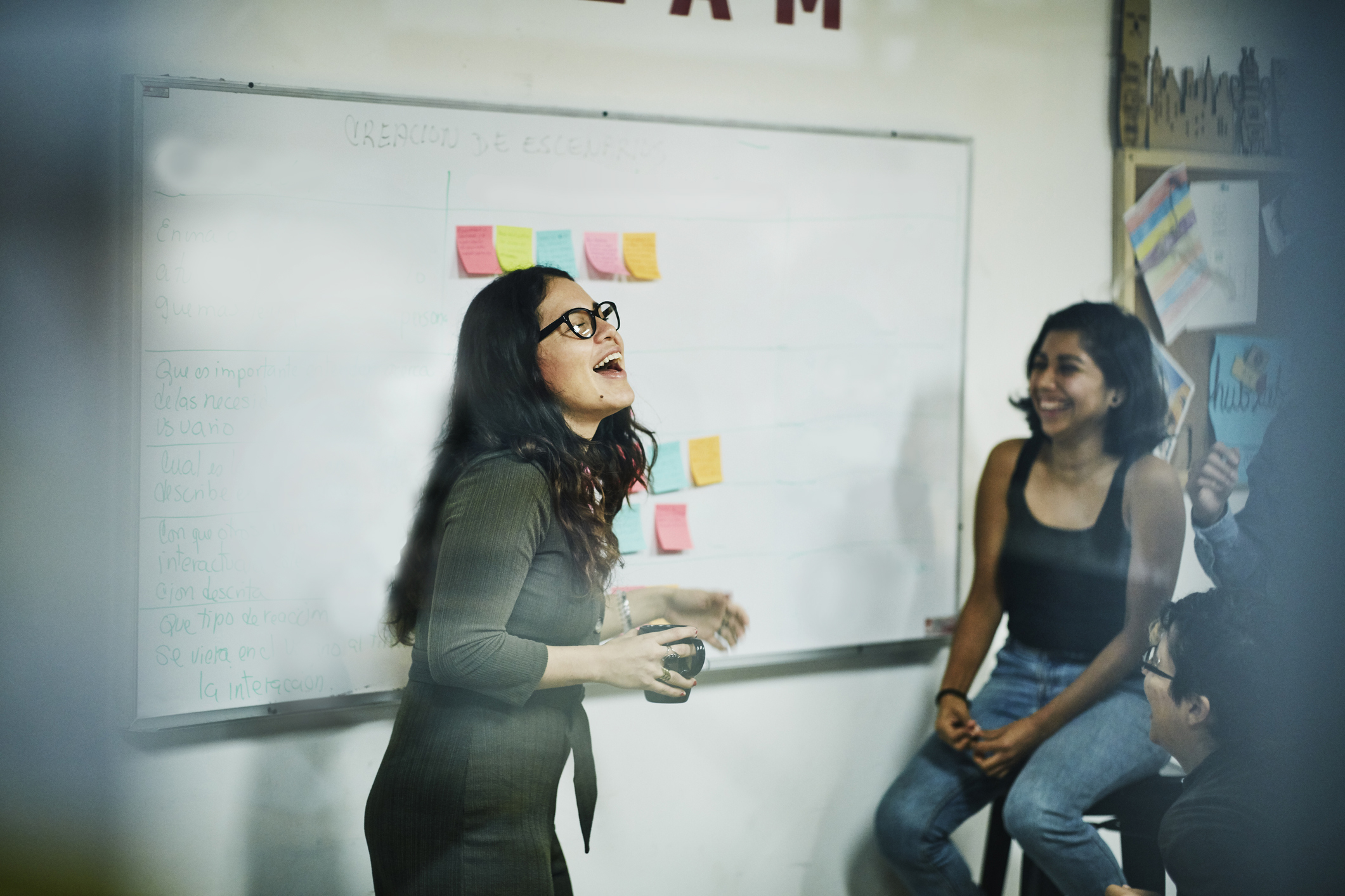 Colleagues presenting in front of a whiteboard