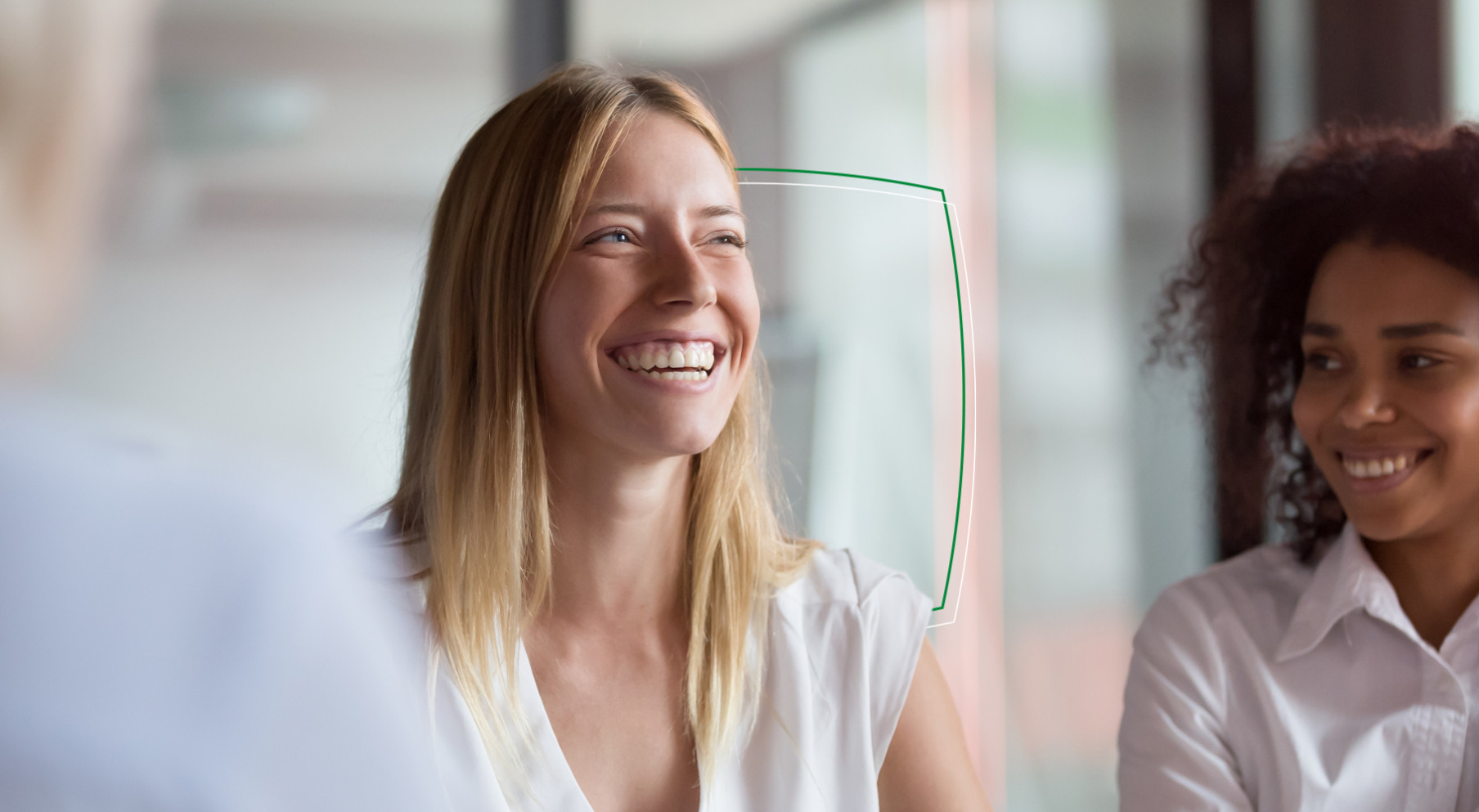 Two colleagues laughing in the office