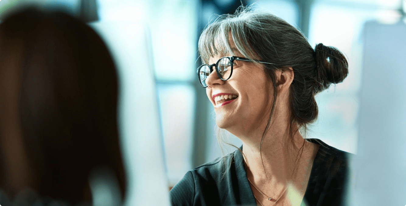 Colleague smiling behind computer