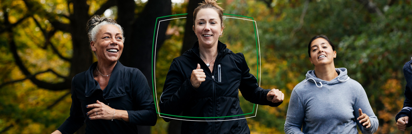 Group of women running through a forest