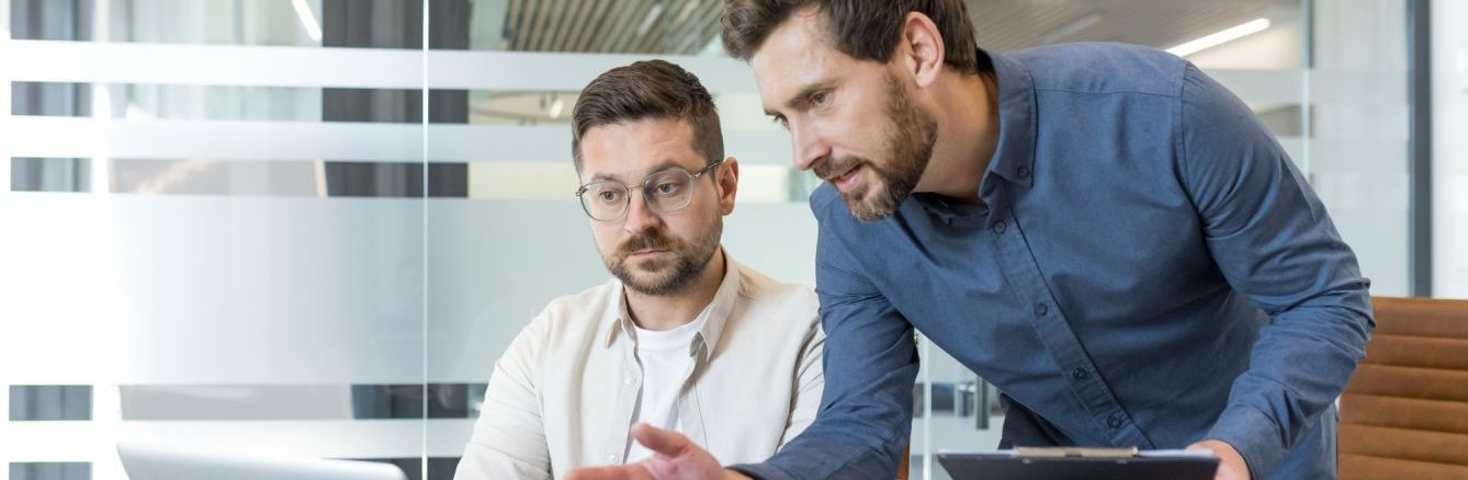 Male_colleagues_reviewing_laptop.jpg