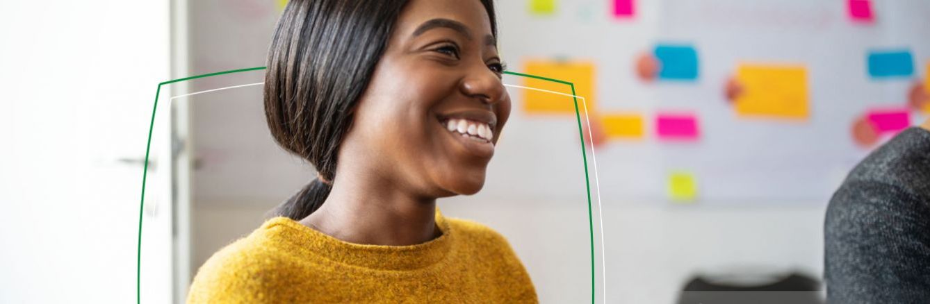 Colleague smiling in front of post-it note wall