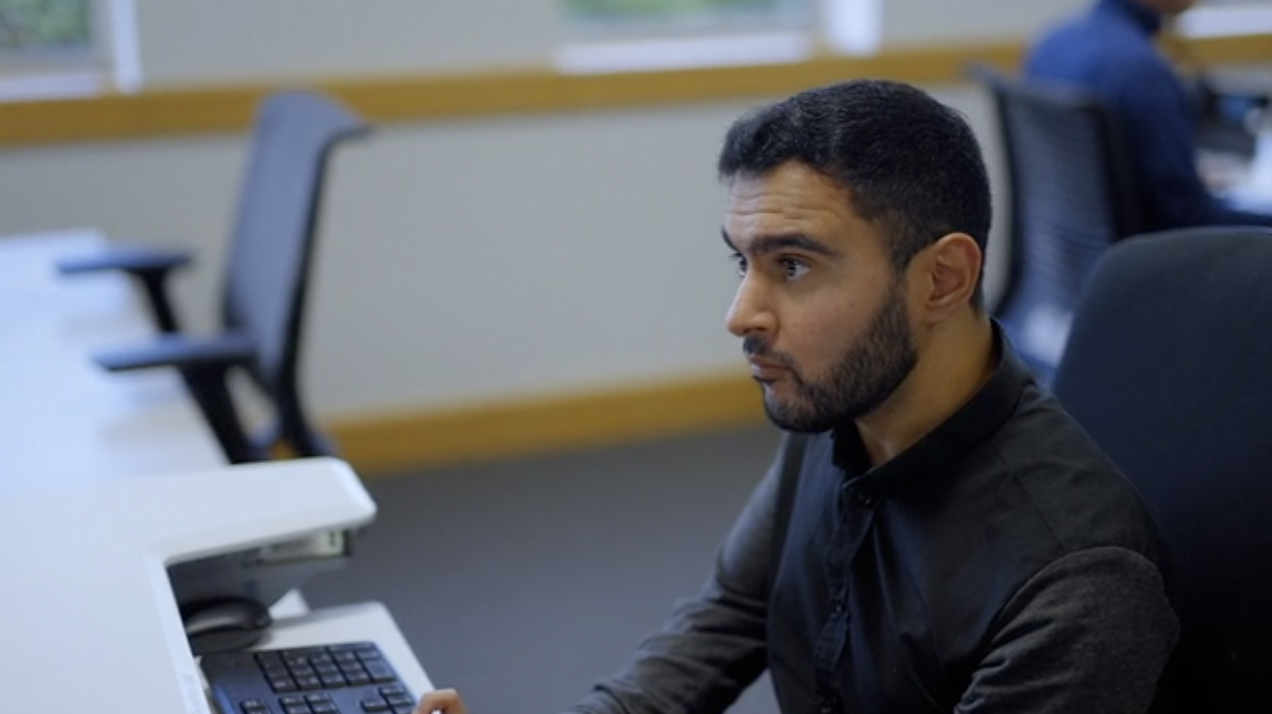 Male colleague working on laptop