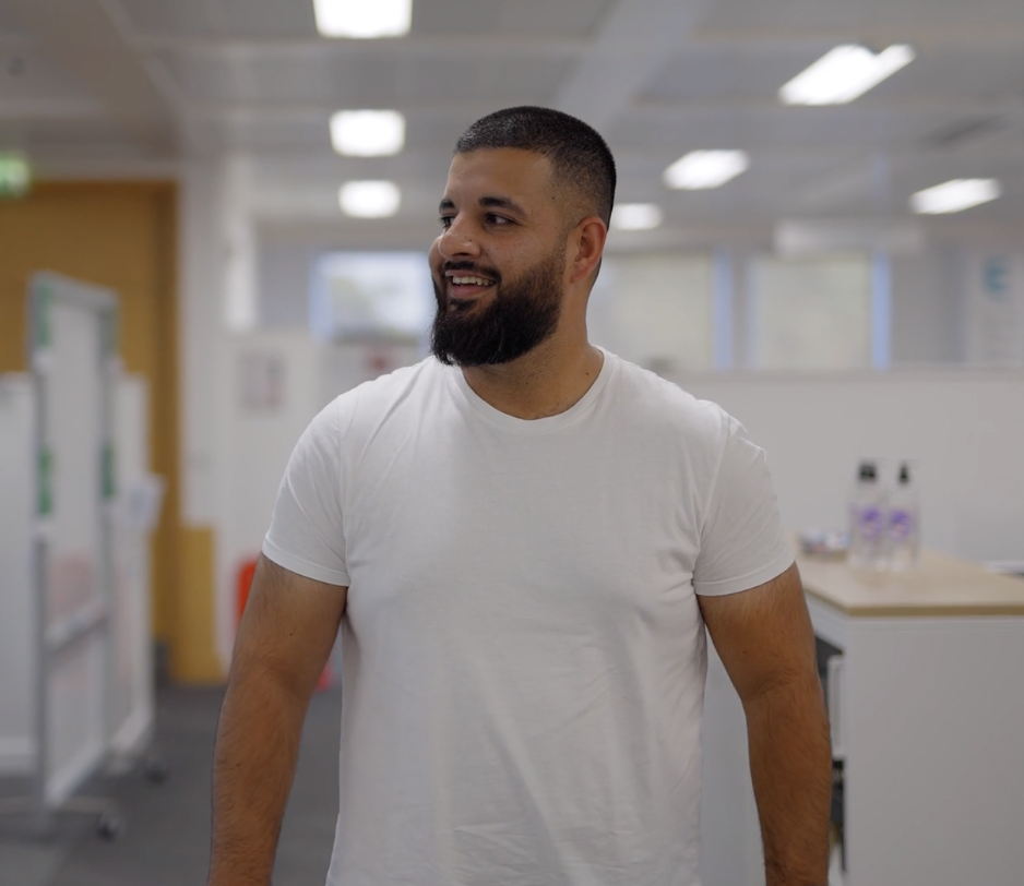 Colleague smiling and walking through office