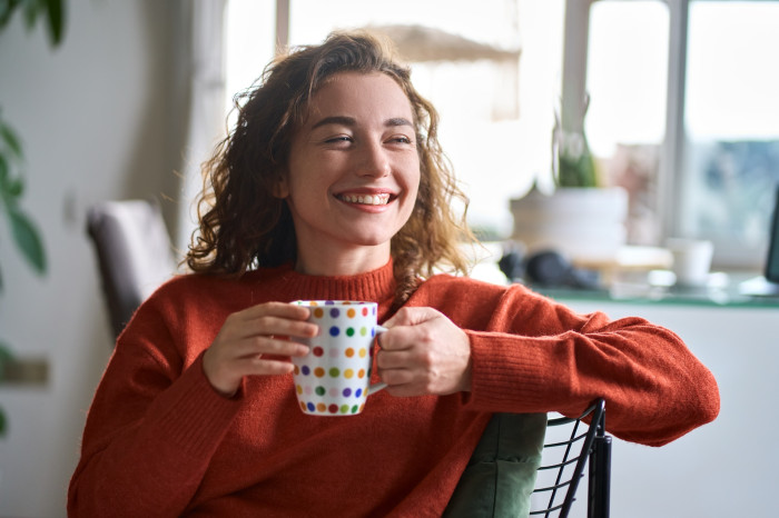 Colleague_smiling_whilst_holding_a_mug.jpg